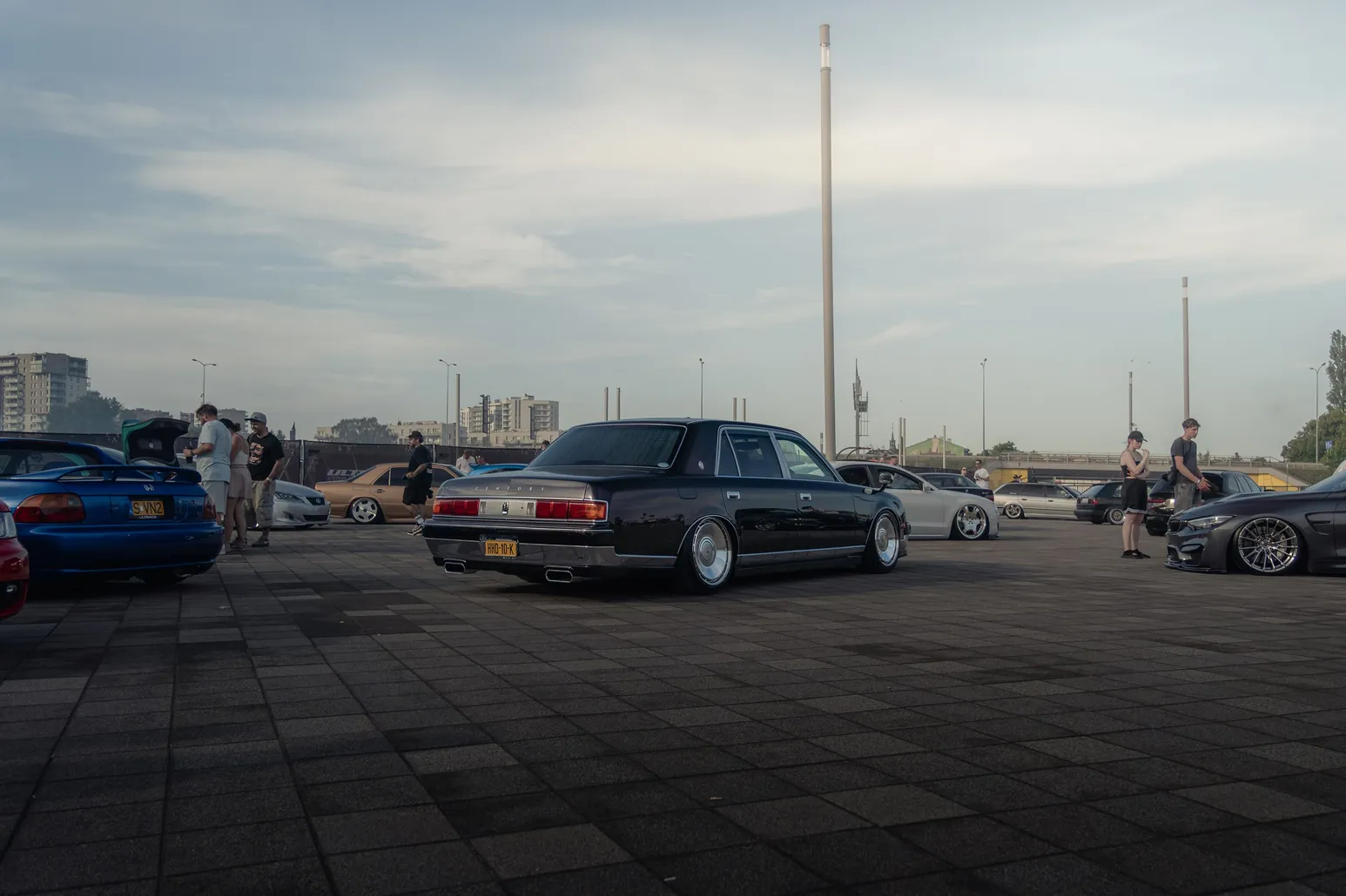 Black sedan on the wide square in evening light