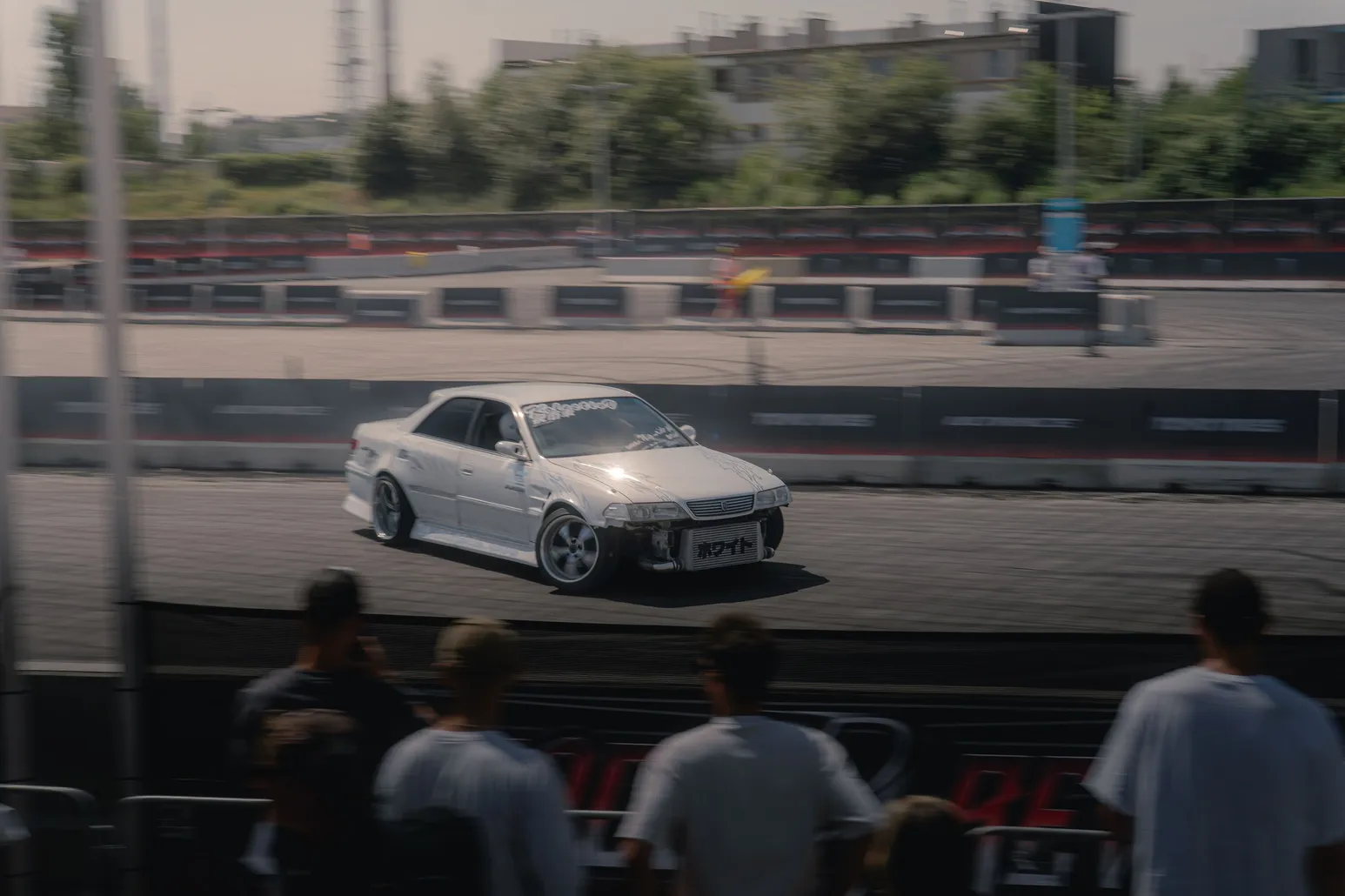 White BMW drifting in front of the crowd