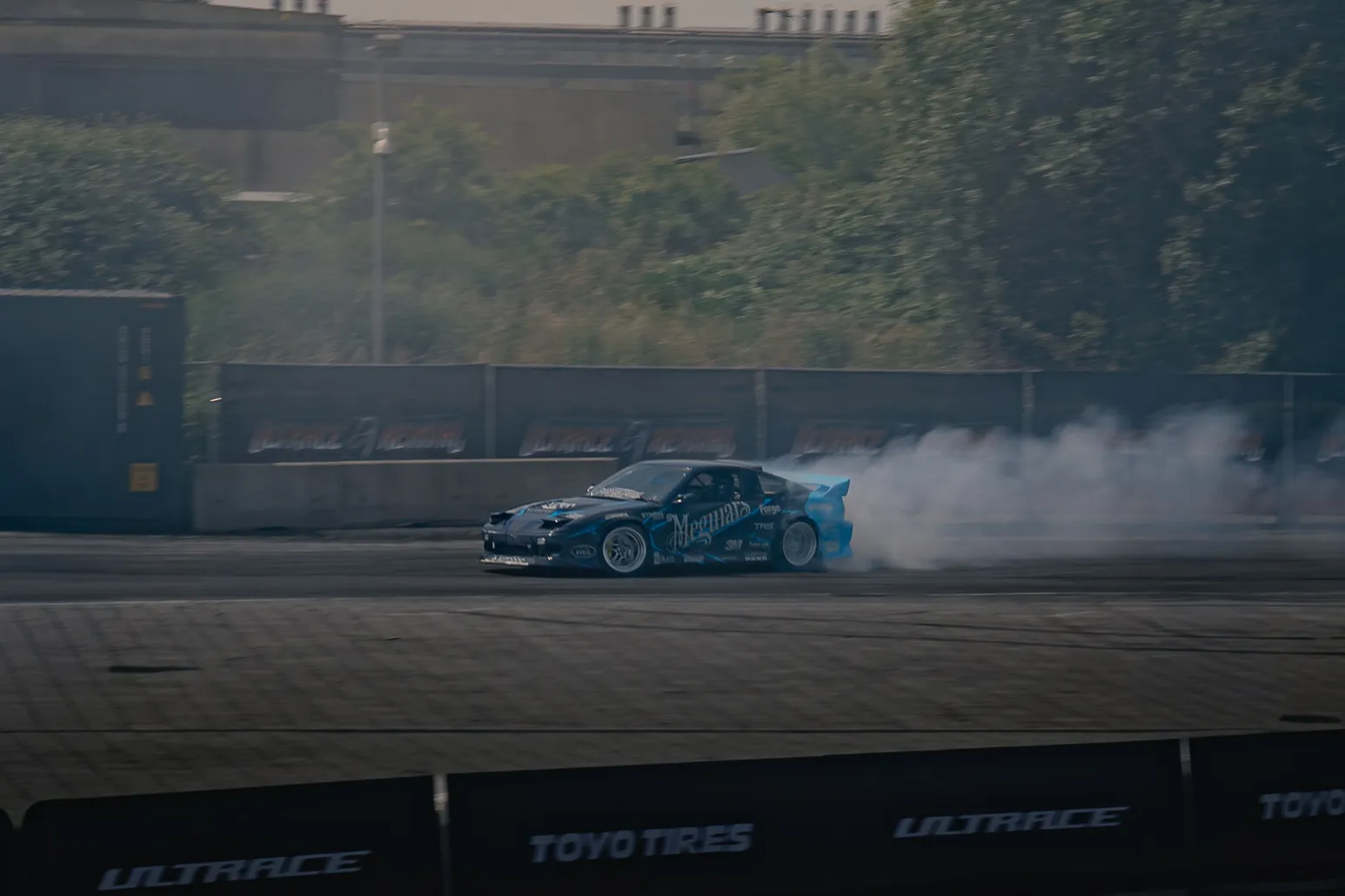 Blue drift car with a long smoke trail
