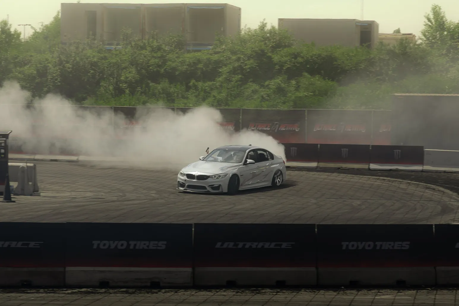 White BMW M4 drifting with tyre smoke