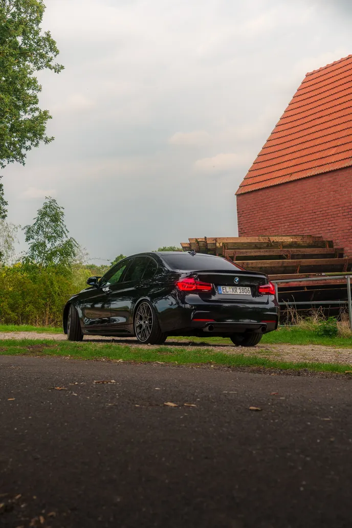 BMW F30 rear beside the barn, portrait format