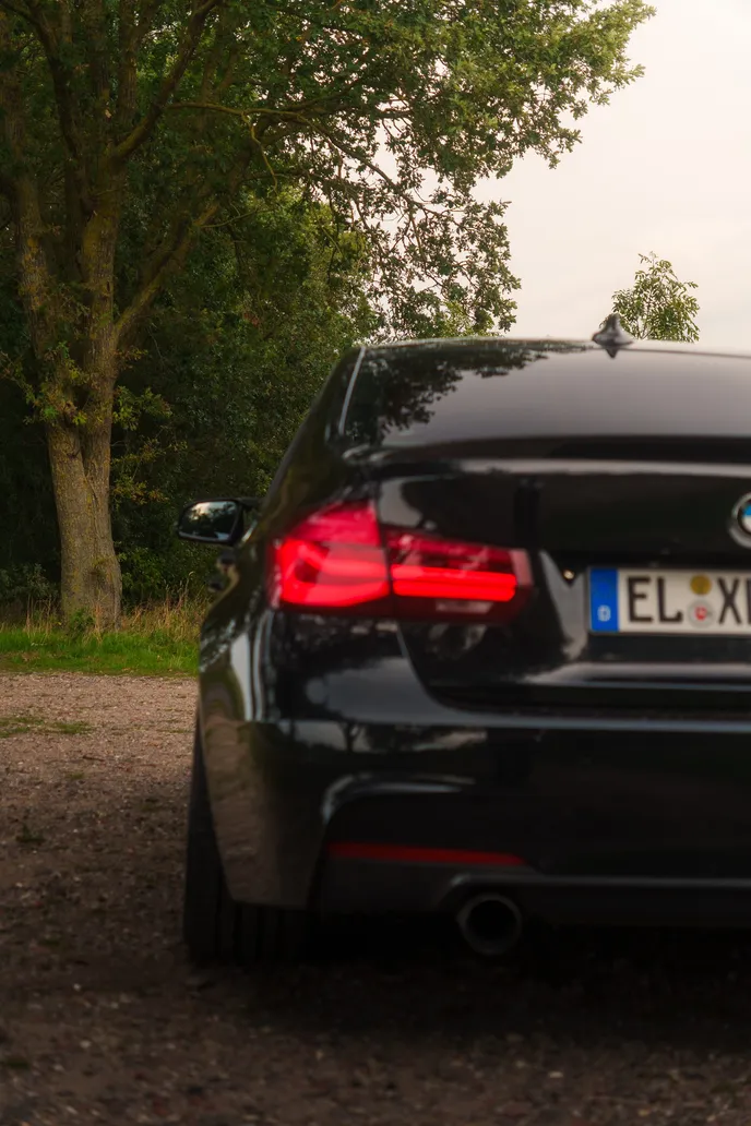 BMW F30 tail lights glowing, portrait format