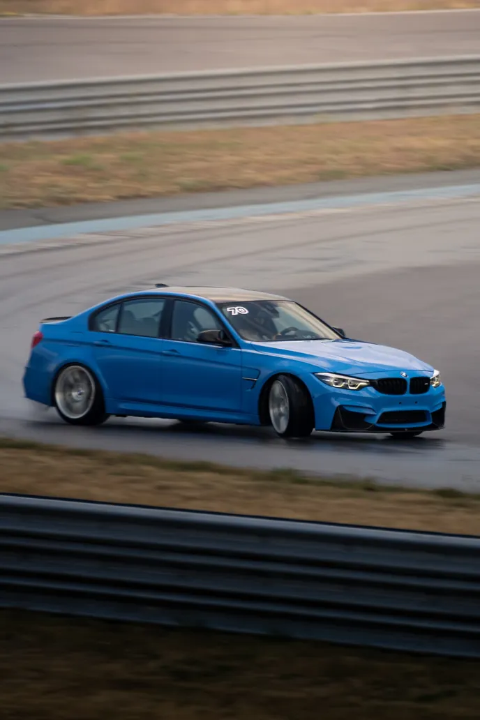 Blue BMW M3 in the pit lane, portrait format