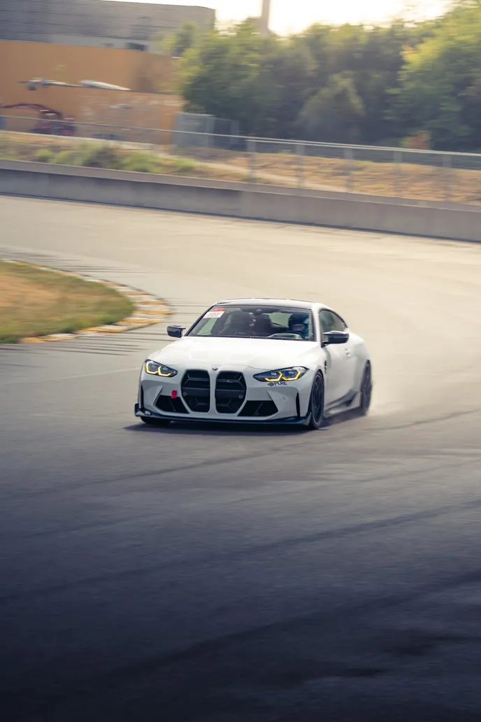 White BMW M4 sliding towards the camera