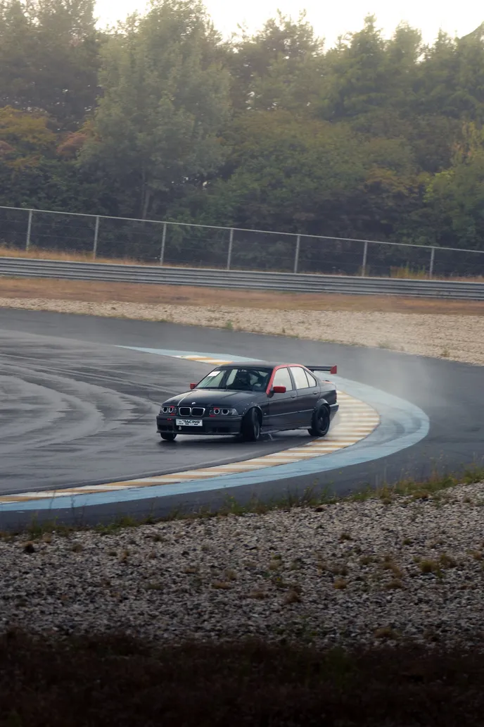 BMW E36 drifting past the kerbs