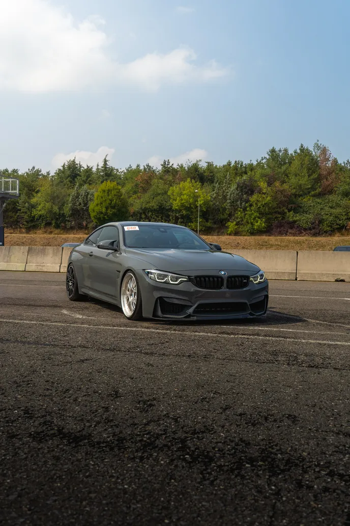 Grey BMW M4 in the paddock, portrait format