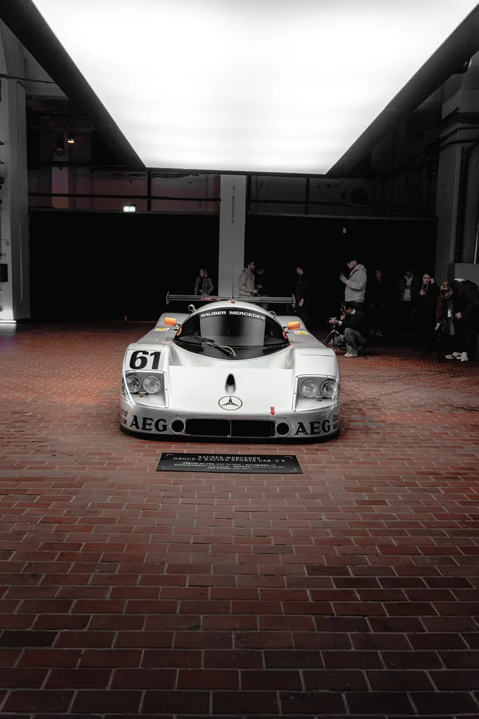 Group C race car head-on under the light ceiling, portrait format