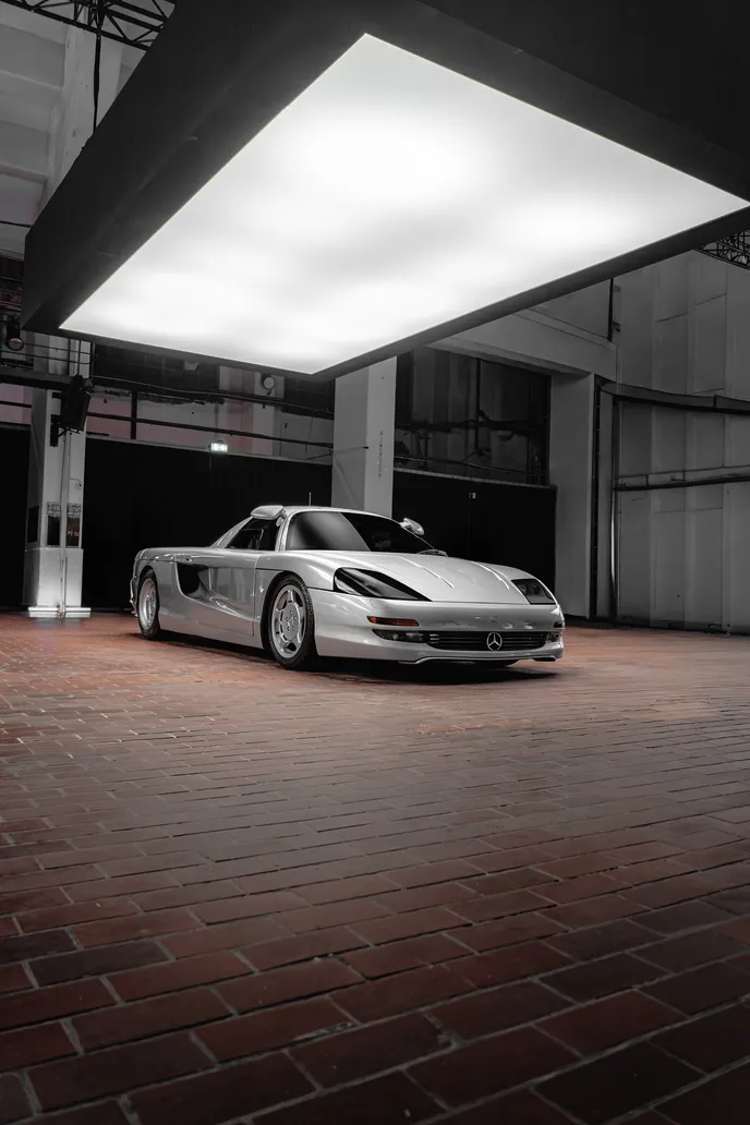 Silver supercar on a brick floor, portrait format
