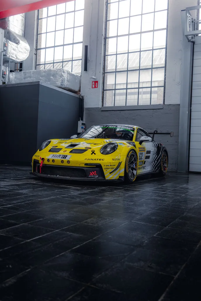 Yellow Porsche 911 GT3 R in the hall, portrait format