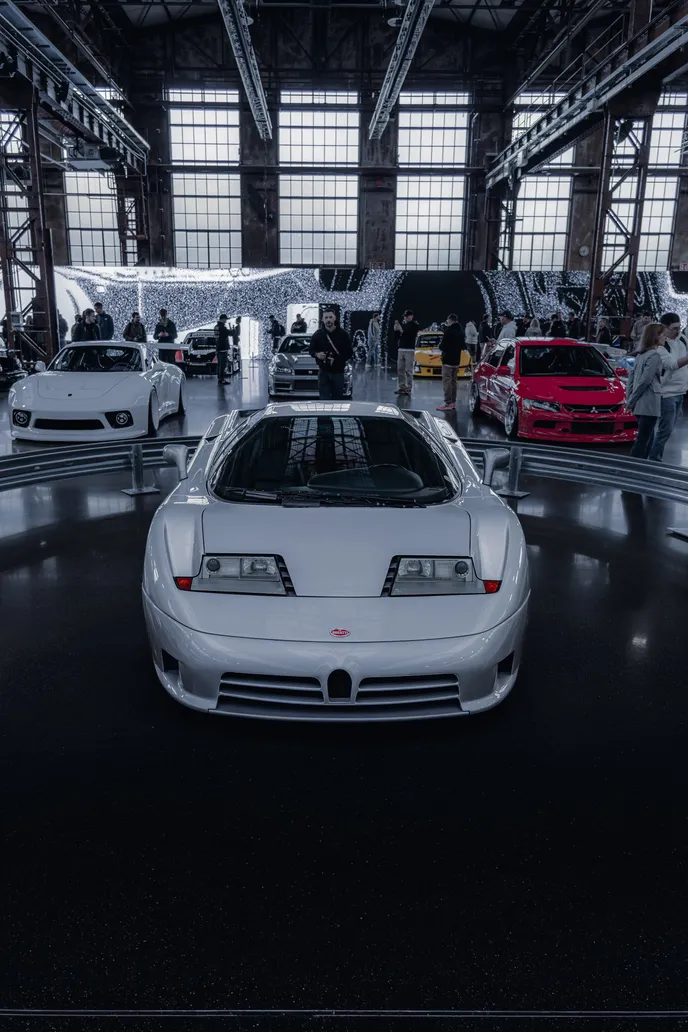 White Bugatti EB110 head-on in the hall, portrait format