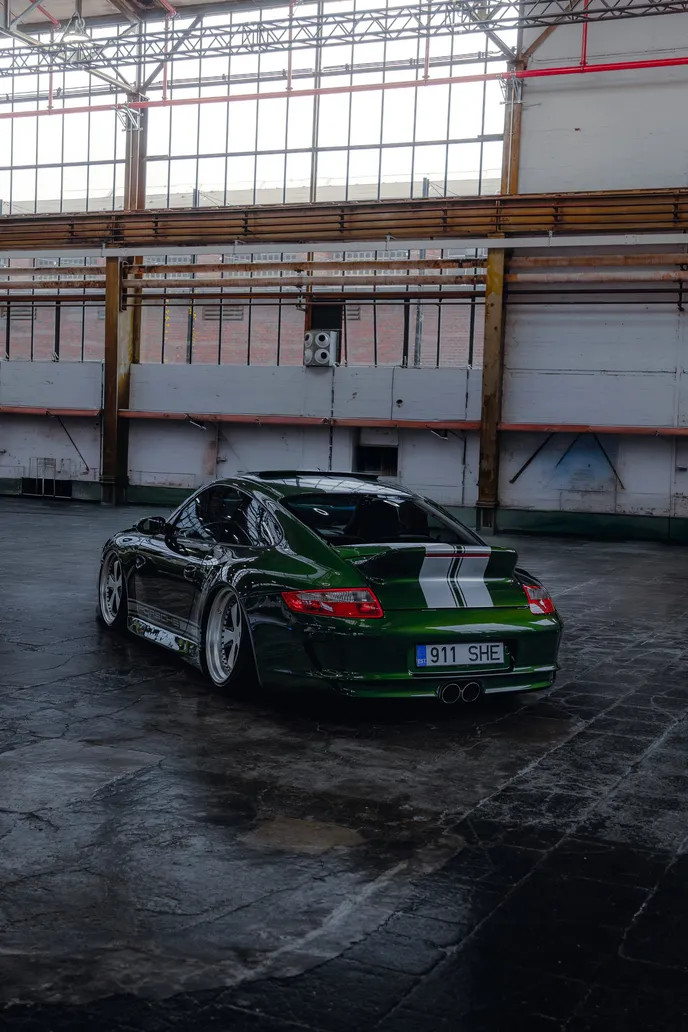 Green Porsche 911 from behind in the hall, portrait format
