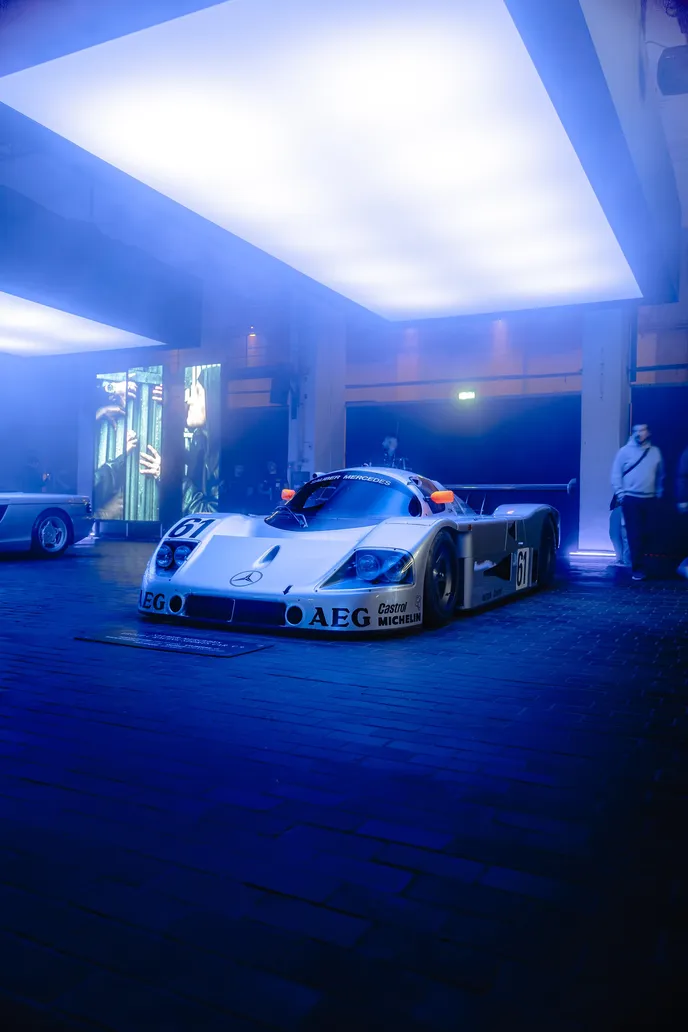 Group C race car in blue light under the light ceiling, portrait format