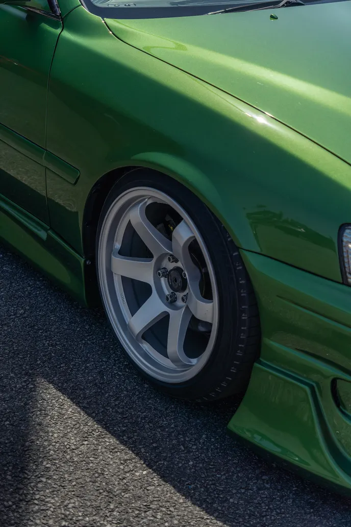 Wheel and fender of the green Chaser in detail, portrait format